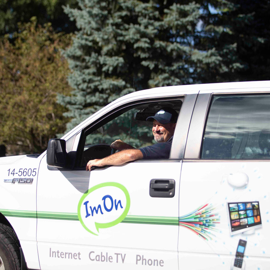 ImOn construction technician driving his ImOn truck in a new service area neighborhood.