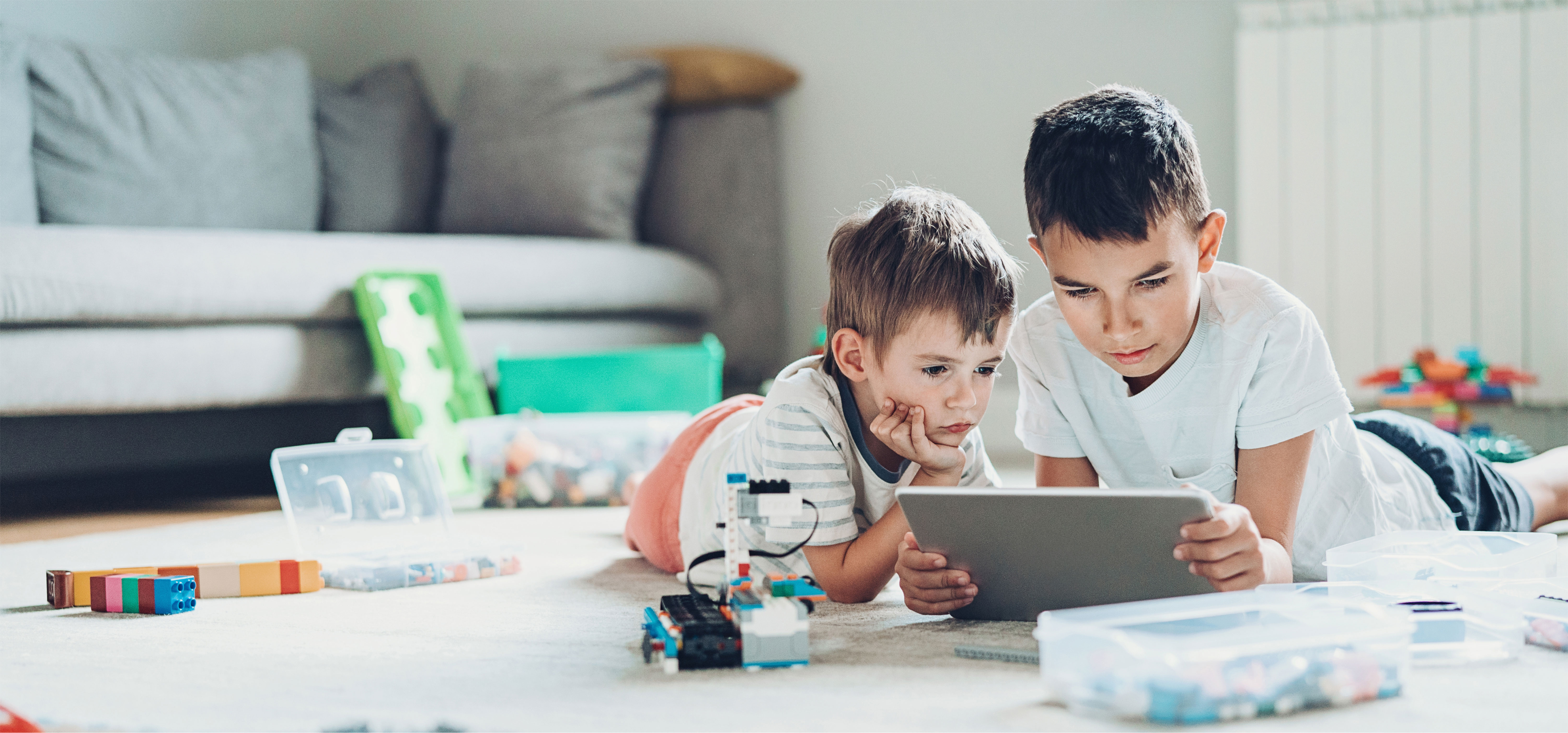 two young boys looking at a tablet