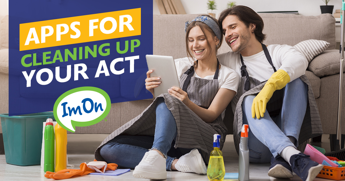 Couple sitting on floor looking at tablet surrounded by cleaning supplies