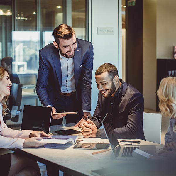 A group of coworkers around a table discussing a business project