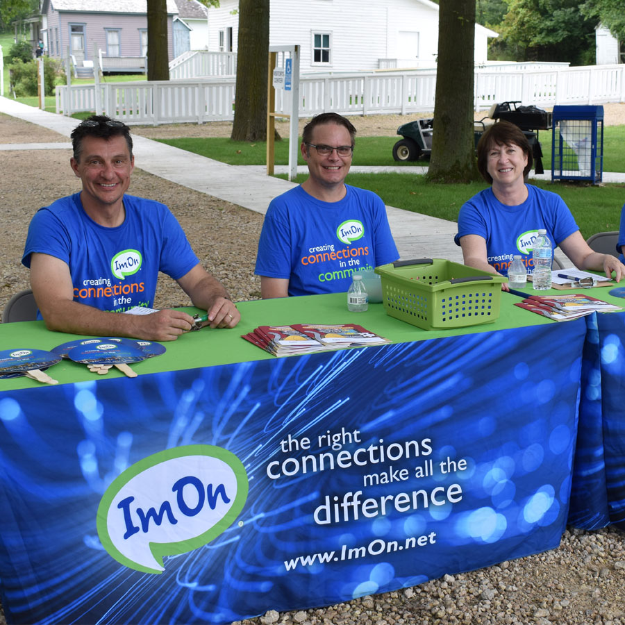 Circle-Image-ImOn--Employees-at-Carnival-Booth.jpg