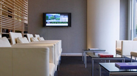A view of the television and sitting area within a business waiting room.